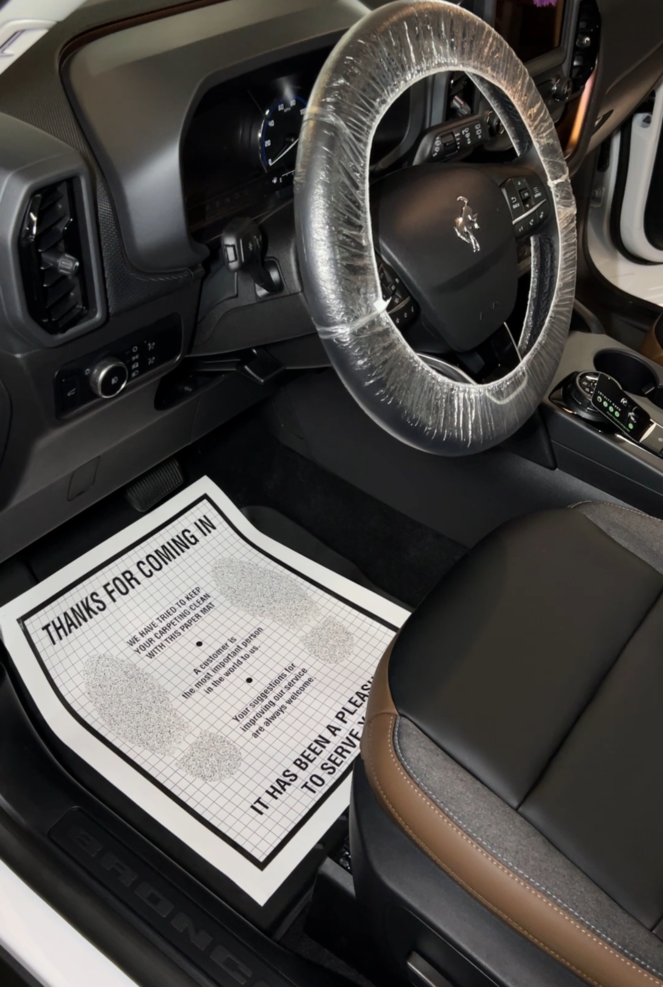 Detailed Ford Bronco steering wheel and front seat area