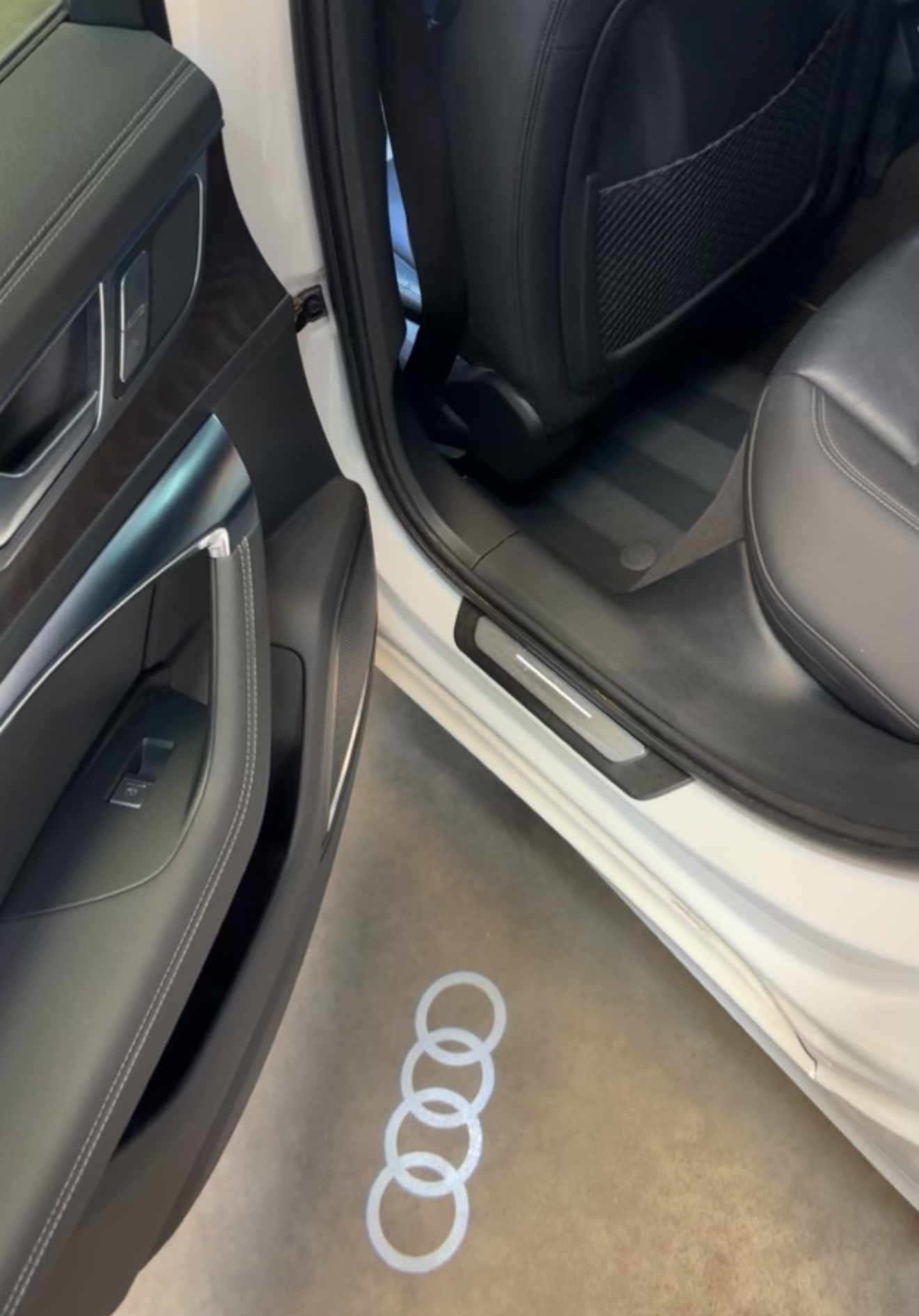 Audi door sill with projected rings logo